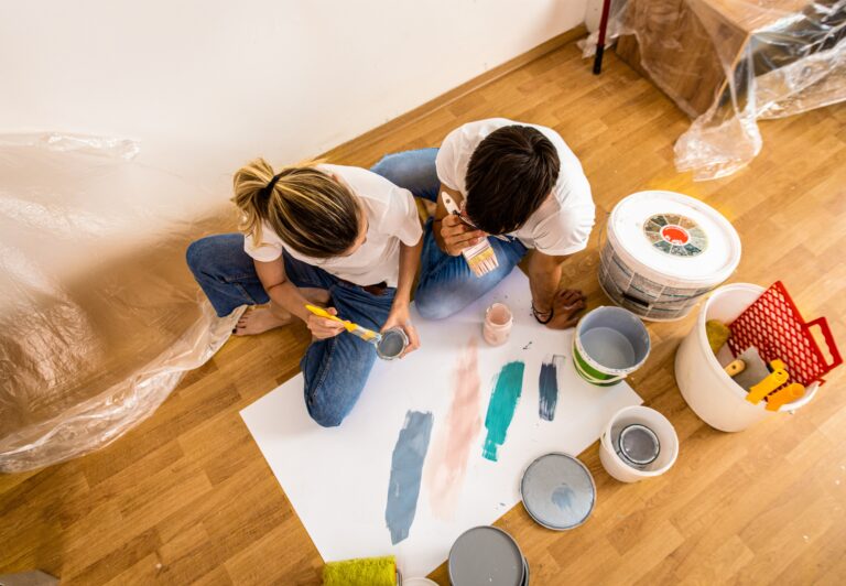 youngcouplesittingonthefloorchoosingcolorforpainting top interior exterior painters victoria bc van isle paint