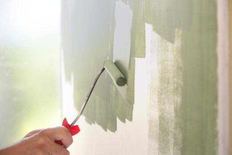 paintrollerprocessofpaintingwithgreenpaintovera top interior exterior painters victoria bc van isle paint